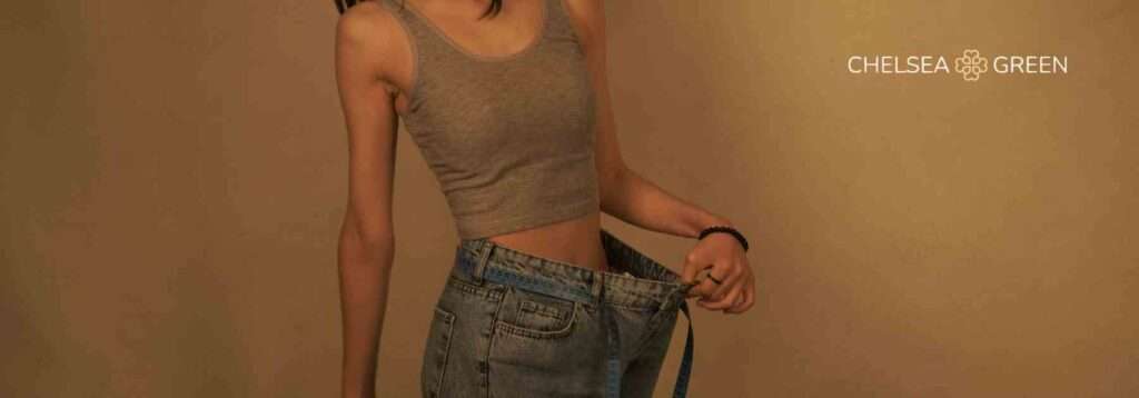 Woman in big jeans after weight loss