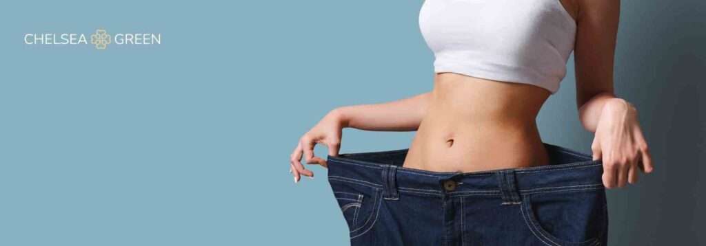 Woman in jeans that are too big to illustrate weight loss on injectables