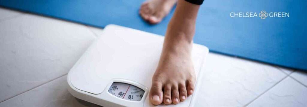 Stepping onto weighing scales 