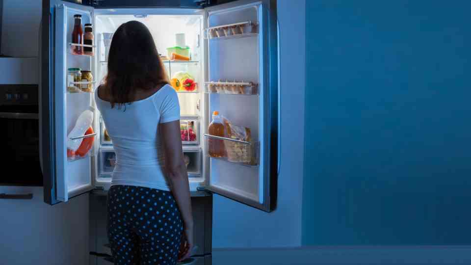Woman accessing food or weight loss medication in the fridge