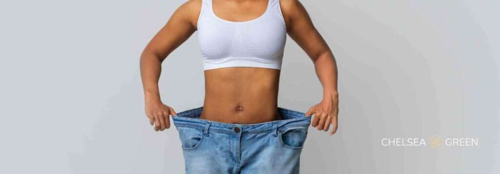 Weight loss progress highlighted by jeans that are too large