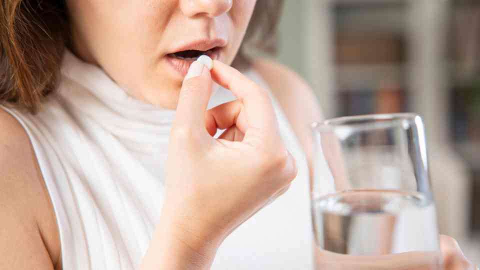 Woman taking Dukarol tablet to prevent cholera