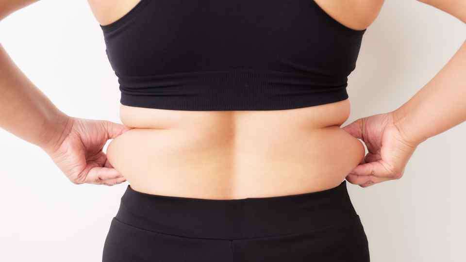 Woman holding fat rolls