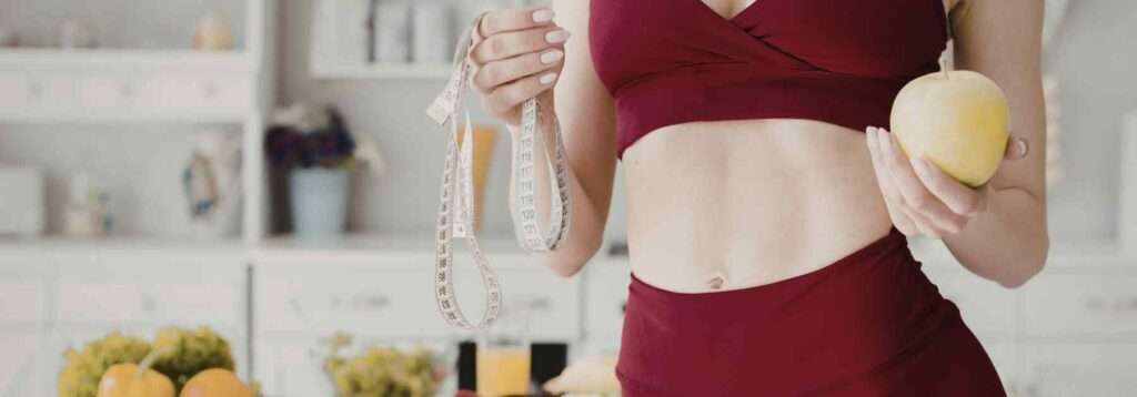 Weight loss success for woman in red gym gear