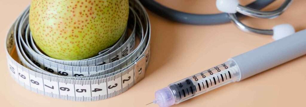 Weight loss pen, fruit, and measuring tape