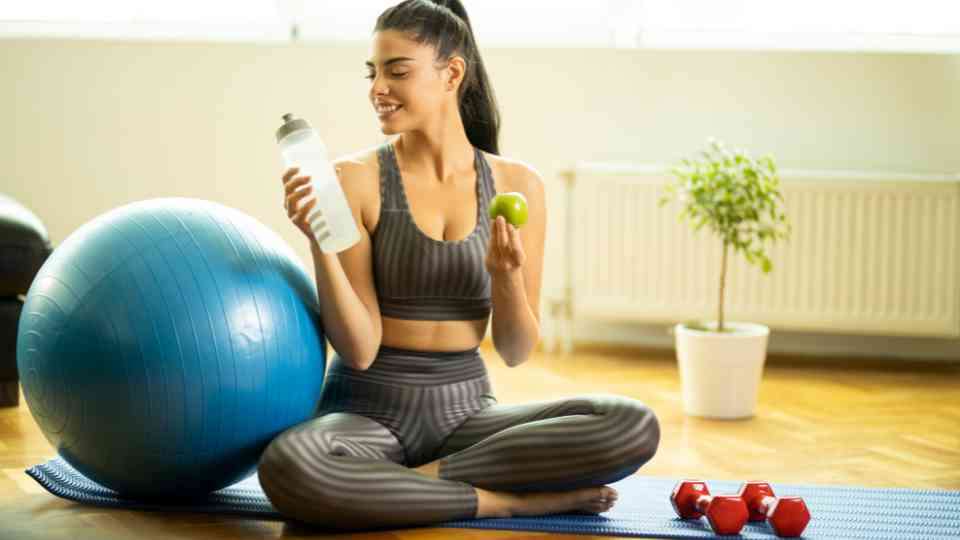 Woman healthy eating and at home workout for weight loss
