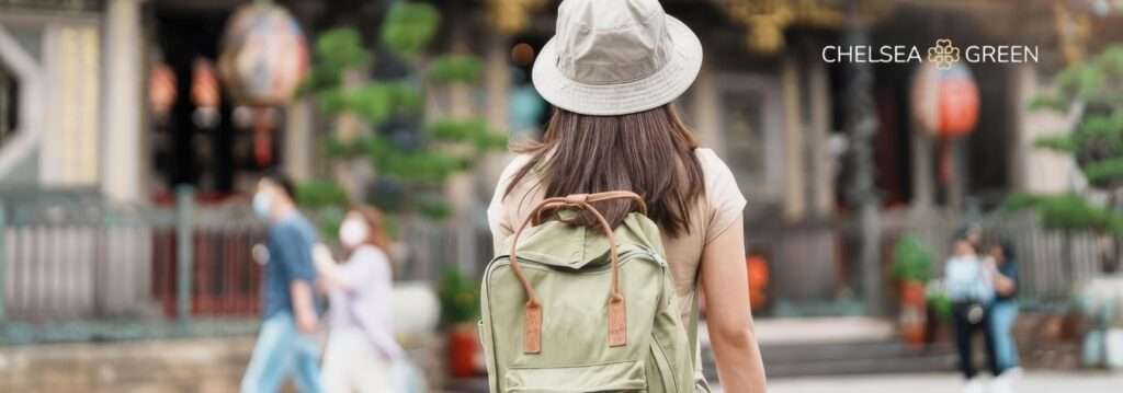 Traveller pictured from behind wearing a backpack