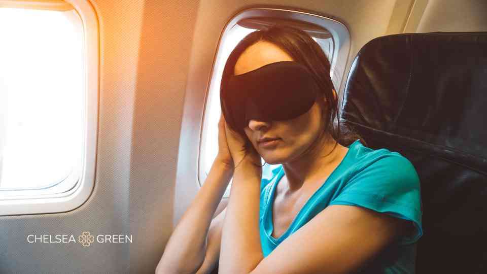Woman asleep on a plane to help combat jet lag