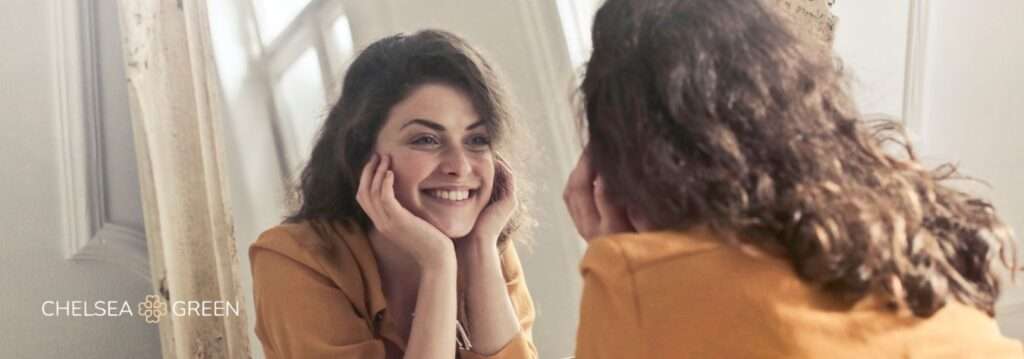 Happy woman admiring weight loss in the mirror